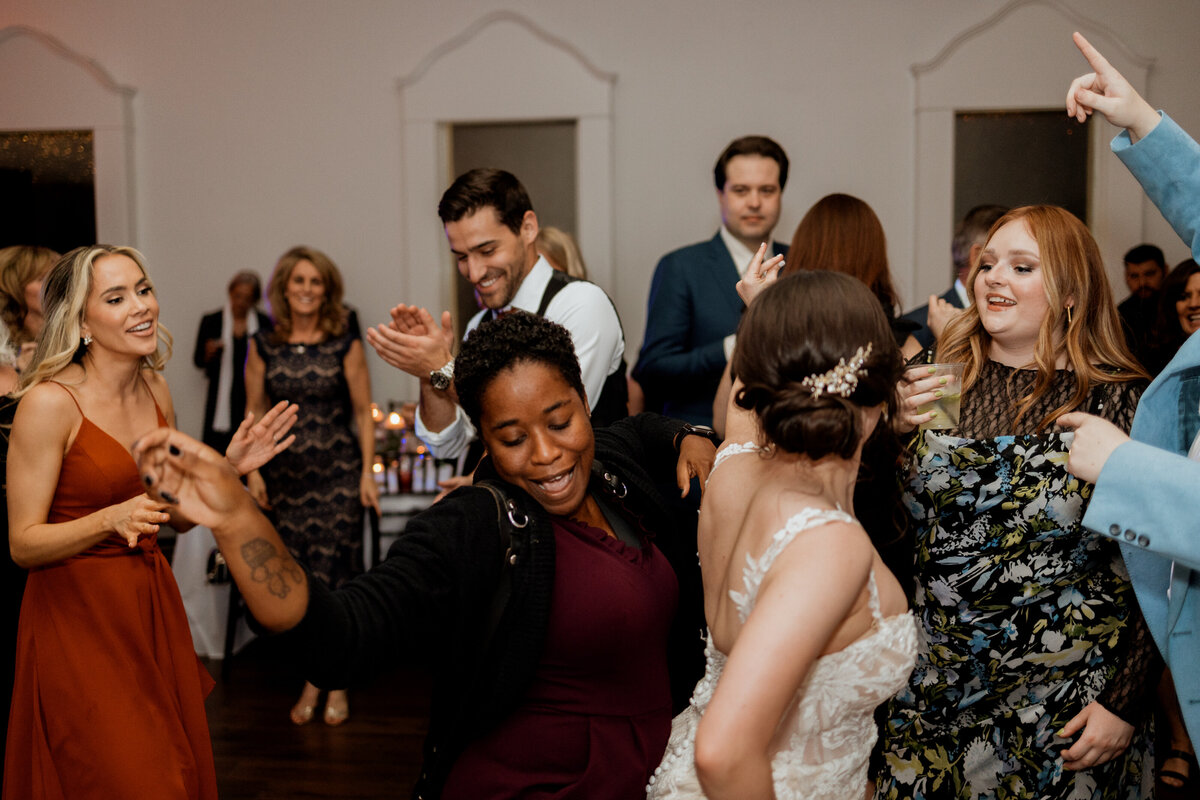 A photographer dancing at a wedding reception.