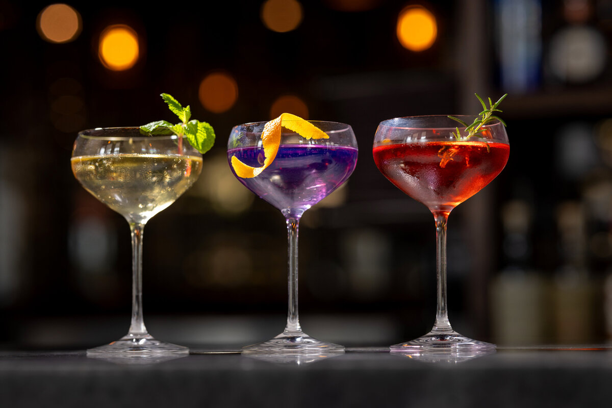 Three cocktails in stemmed glasses