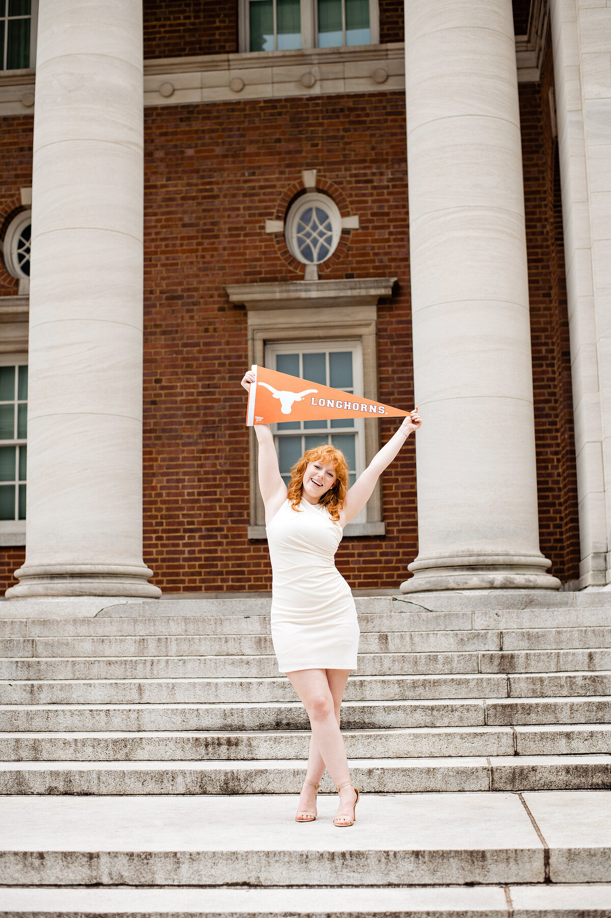 Graduation photo announcing Grad school with a School flag for Texas State