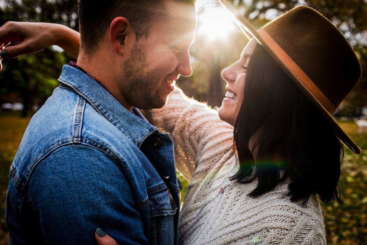 A couple hugs in a ray of sunlight during a Logan Square engagement session.