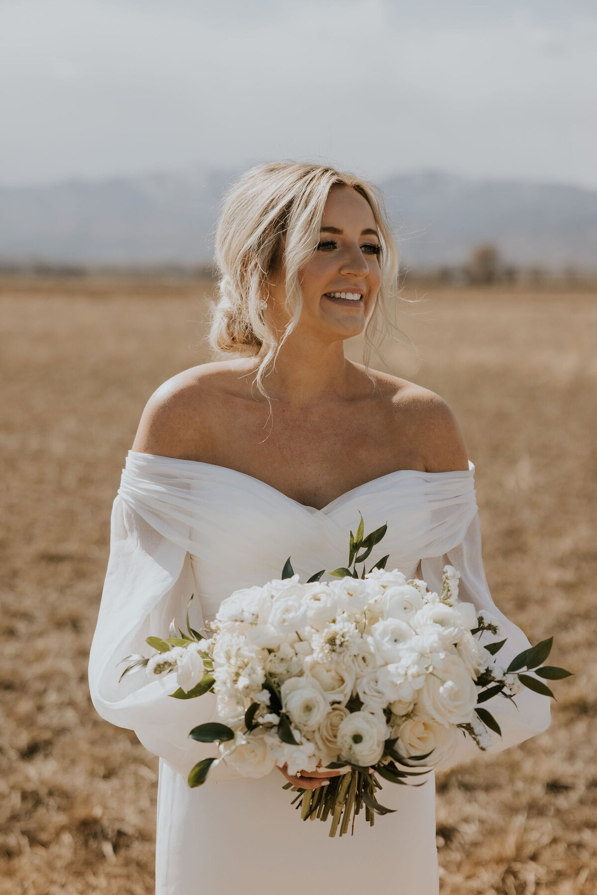 Bridal portait holding white florals at the St Vrain, boulder county wedding venue