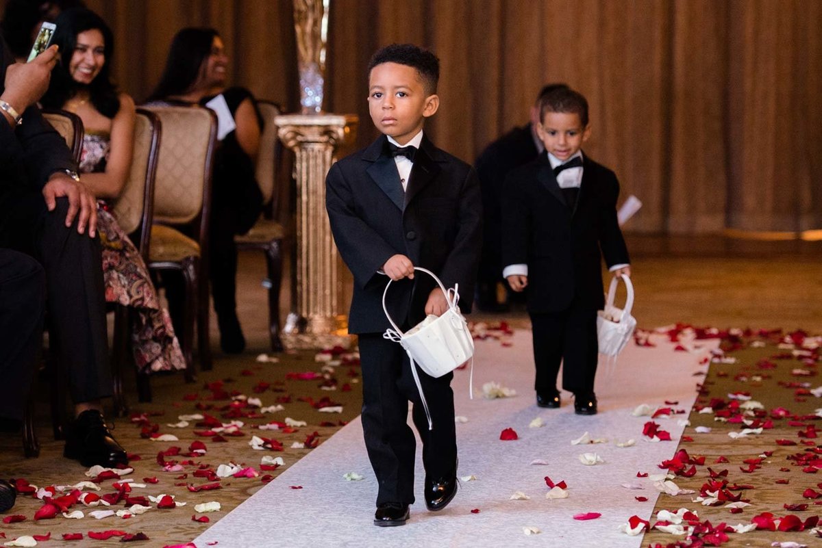 Ring bearers walking down the aisle at The Mansion at Oyster Bay