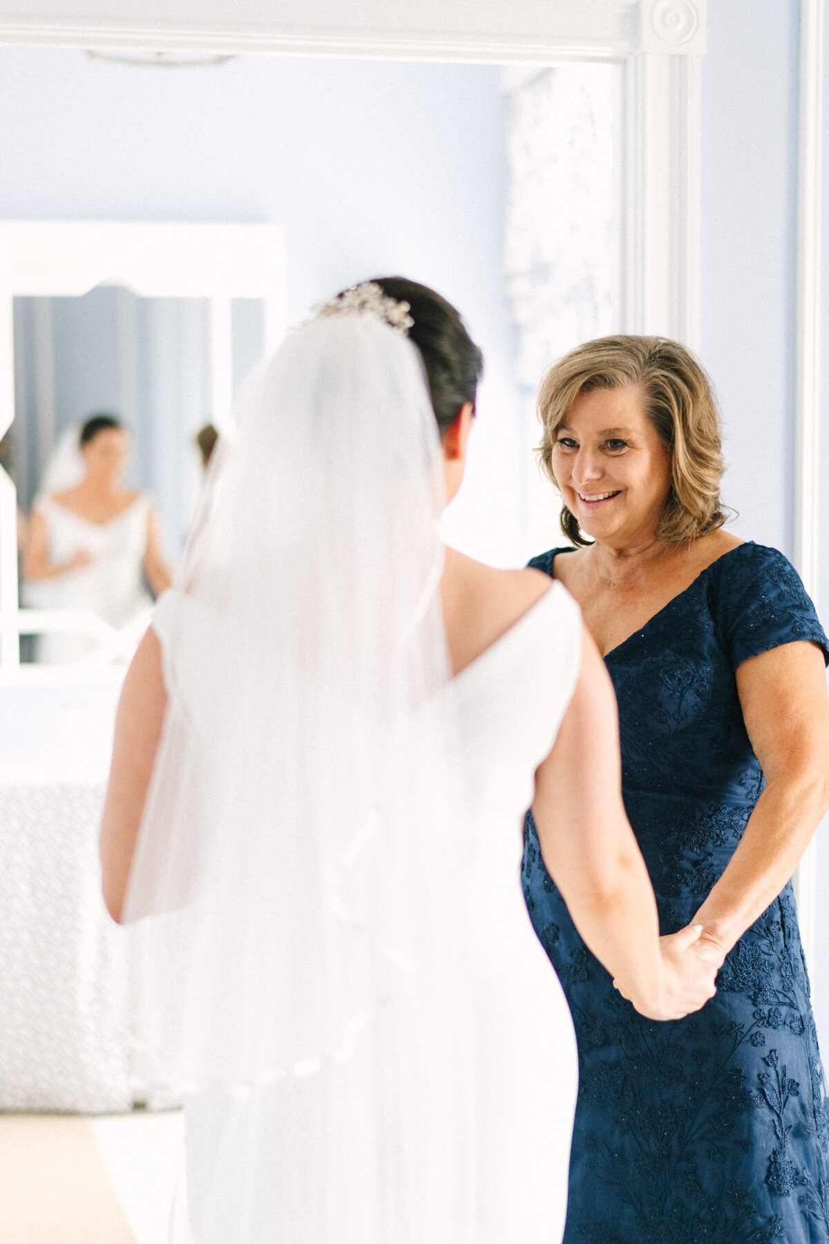 mother of the bride shares a happy moment with the bride