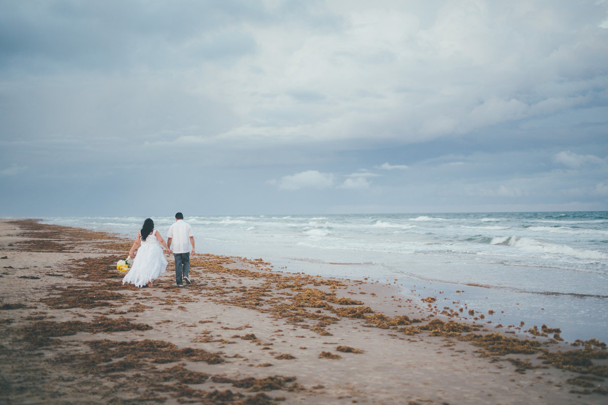 bride and groom walking on the beach at South Padre Island