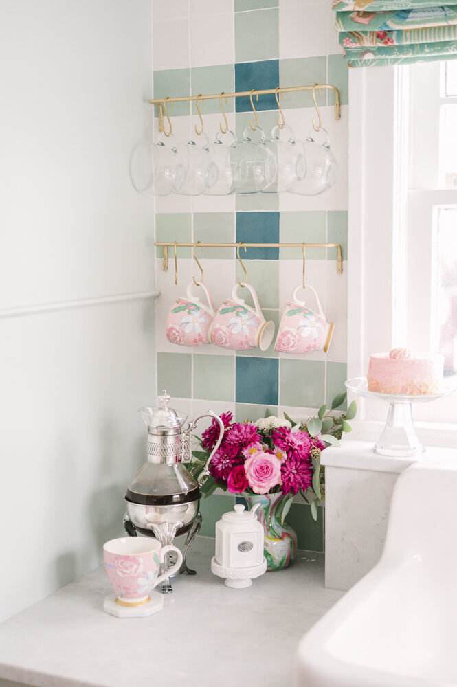 pink mugs sitting on a kitchenette