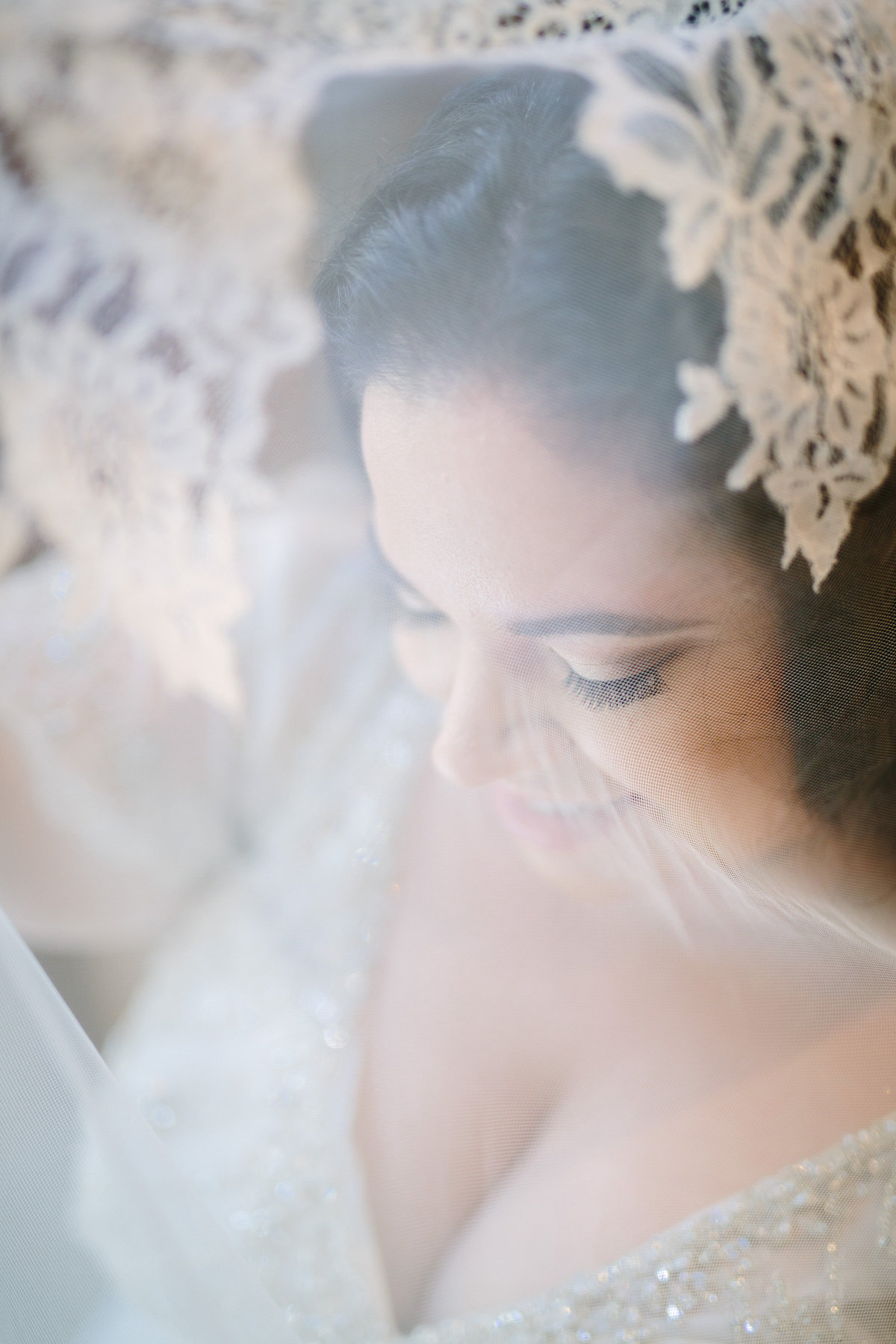 Photo through a brides veil in San Antonio posing for a picture by Expose The Heart Wedding Photography