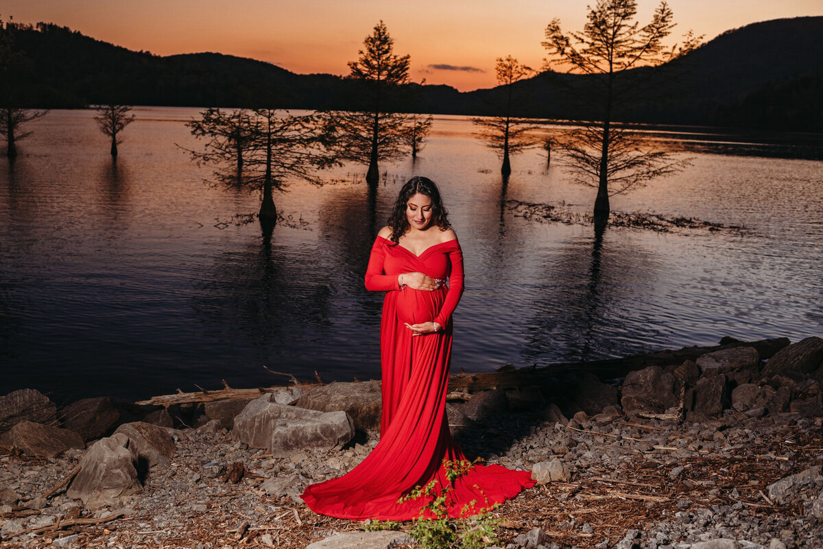 photo of pregnant woman by a lake