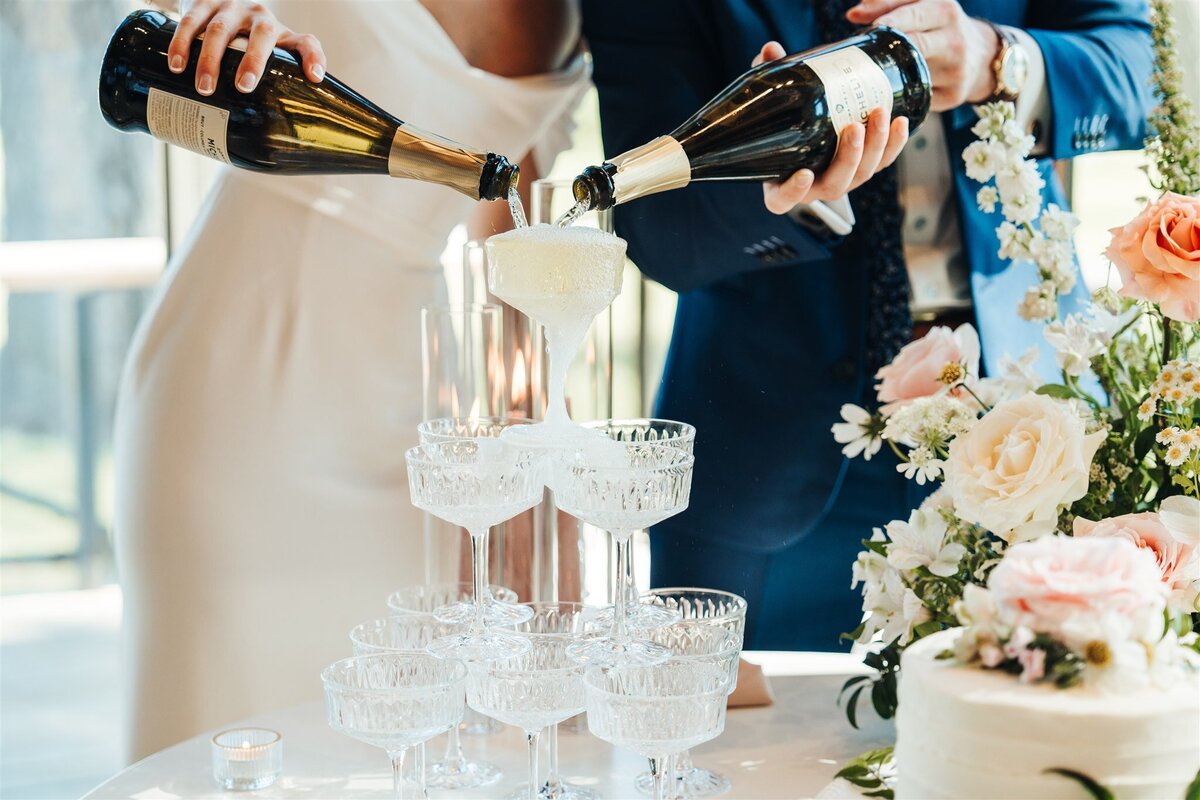 Bride and groom with a champagne tower and flowers at Black Butte Ranch