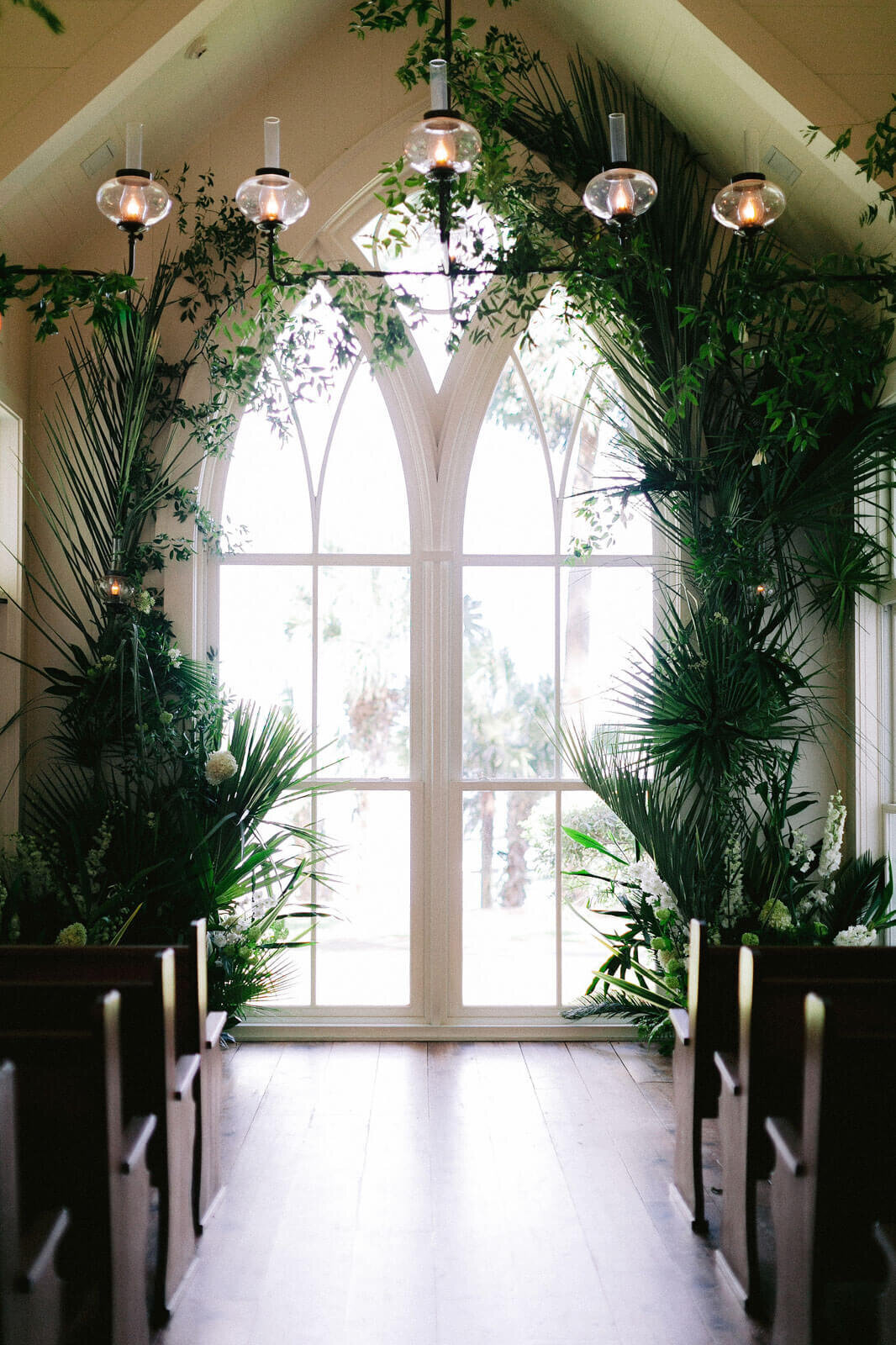 The wedding altar has green plants on both sides in Montage at Palmetto Bluff. Destination wedding image by Jenny Fu Studio