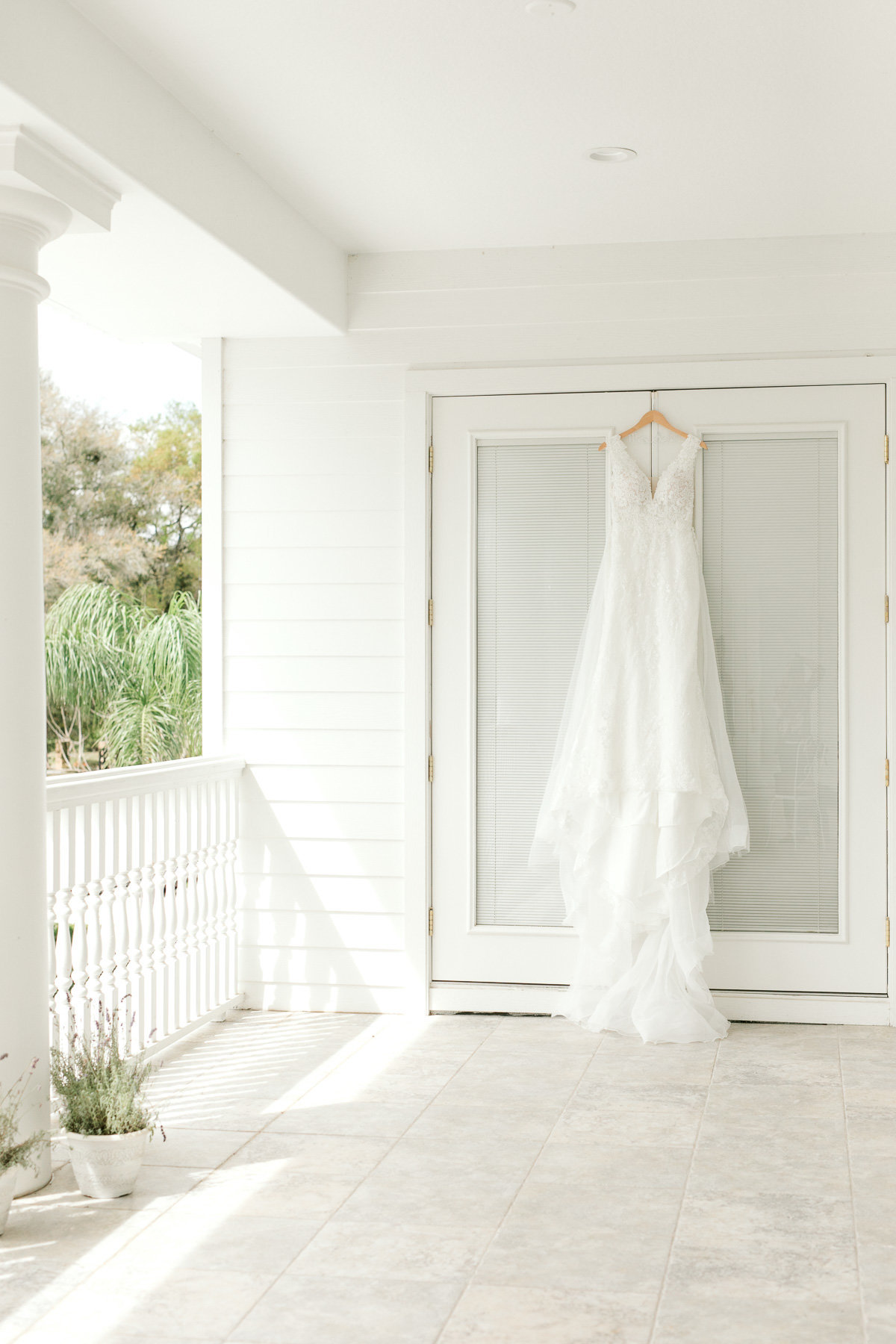 wedding dress hanging on balcony