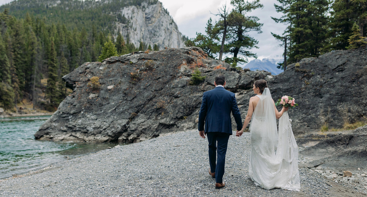 bride groom walking rocks bow falls banff intimate wedding