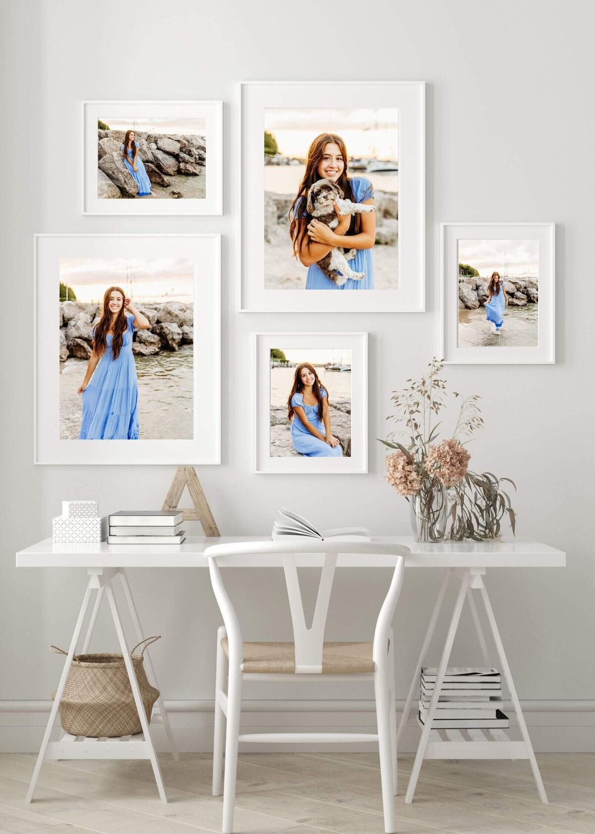 picture of 5 high school senior photos of a girl in a blue dress photos hanging in matted frames hanging over a white desk