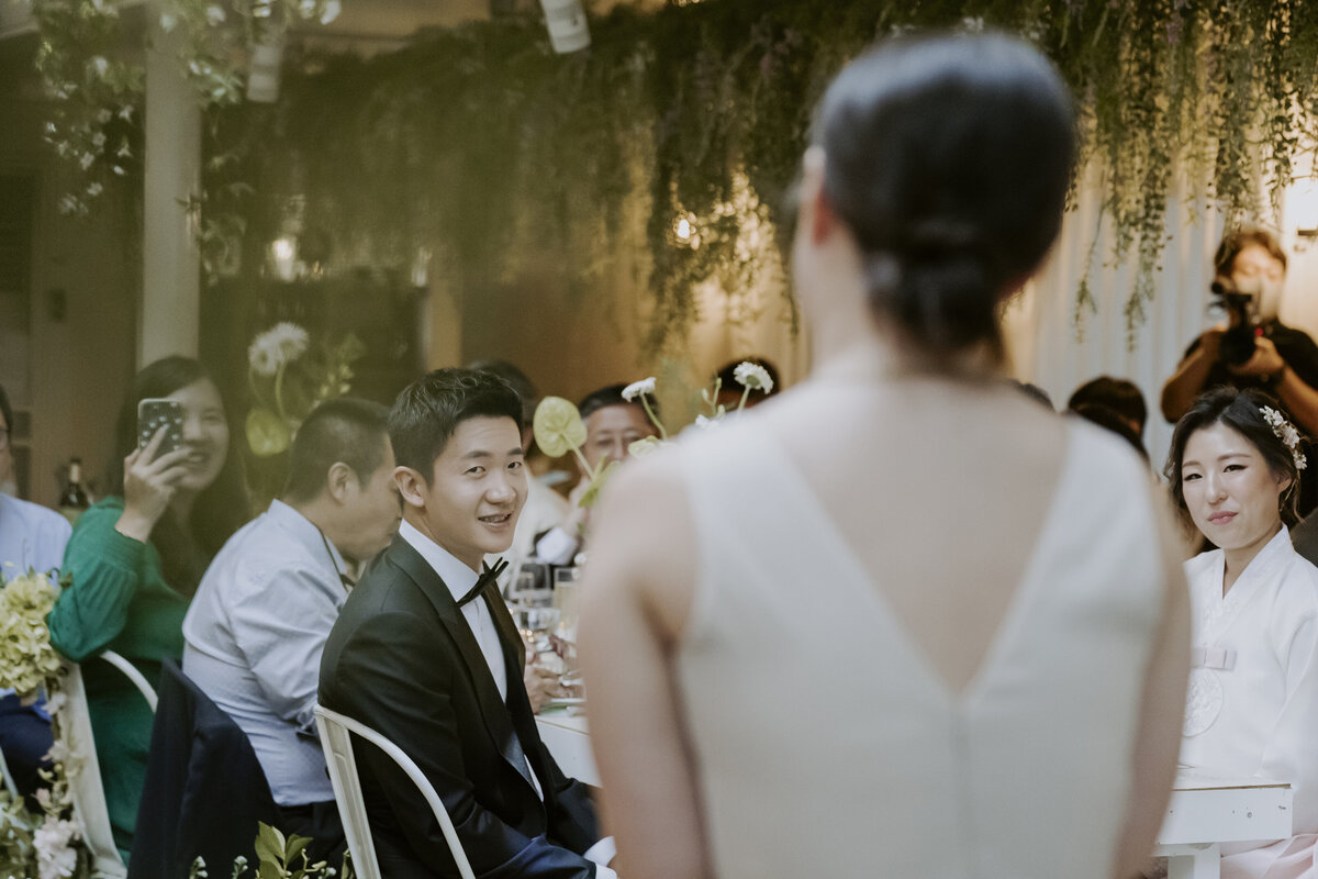 the couple listening to one of their friend's speech