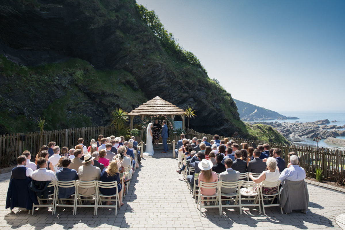 Summer outdoor wedding ceremony at Tunnels Beaches