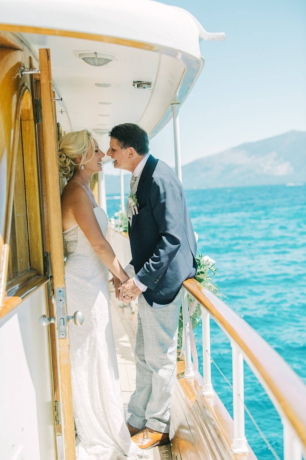 newlyweds posing on boat in Lake Tahoe