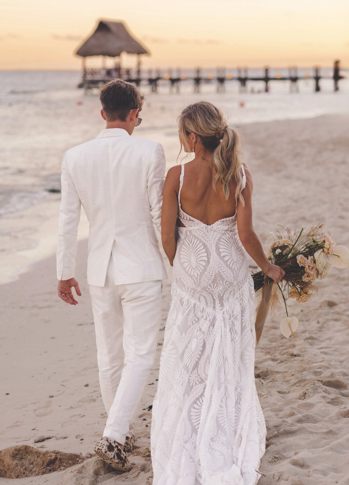 Close up of bide and groom walking in beach in Riviera Maya
