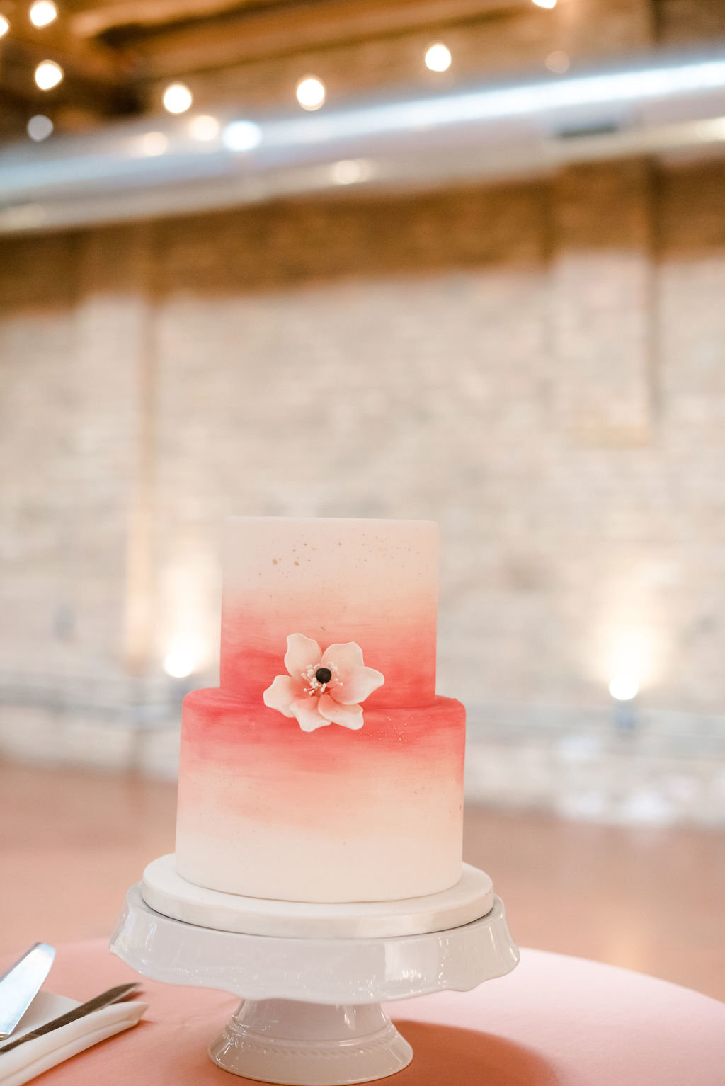 A white and pink ombre style wedding cake