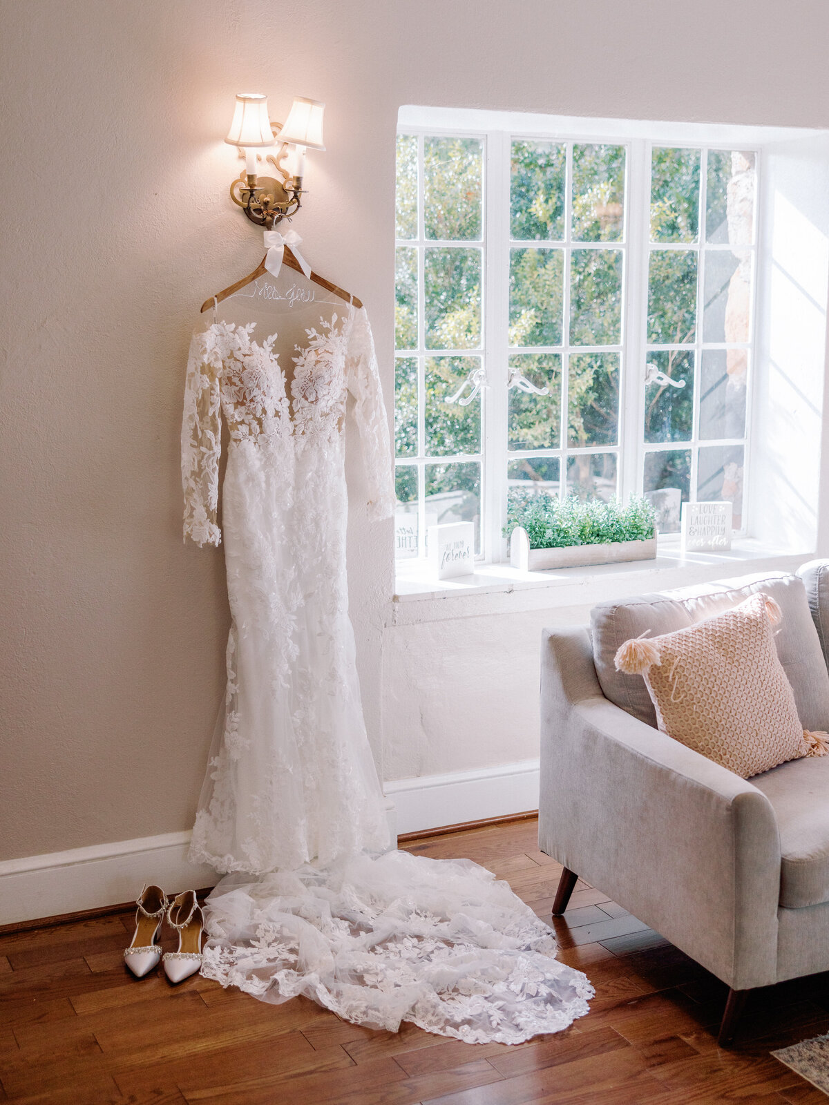 The bride's lace long sleeve wedding dress on a hanger