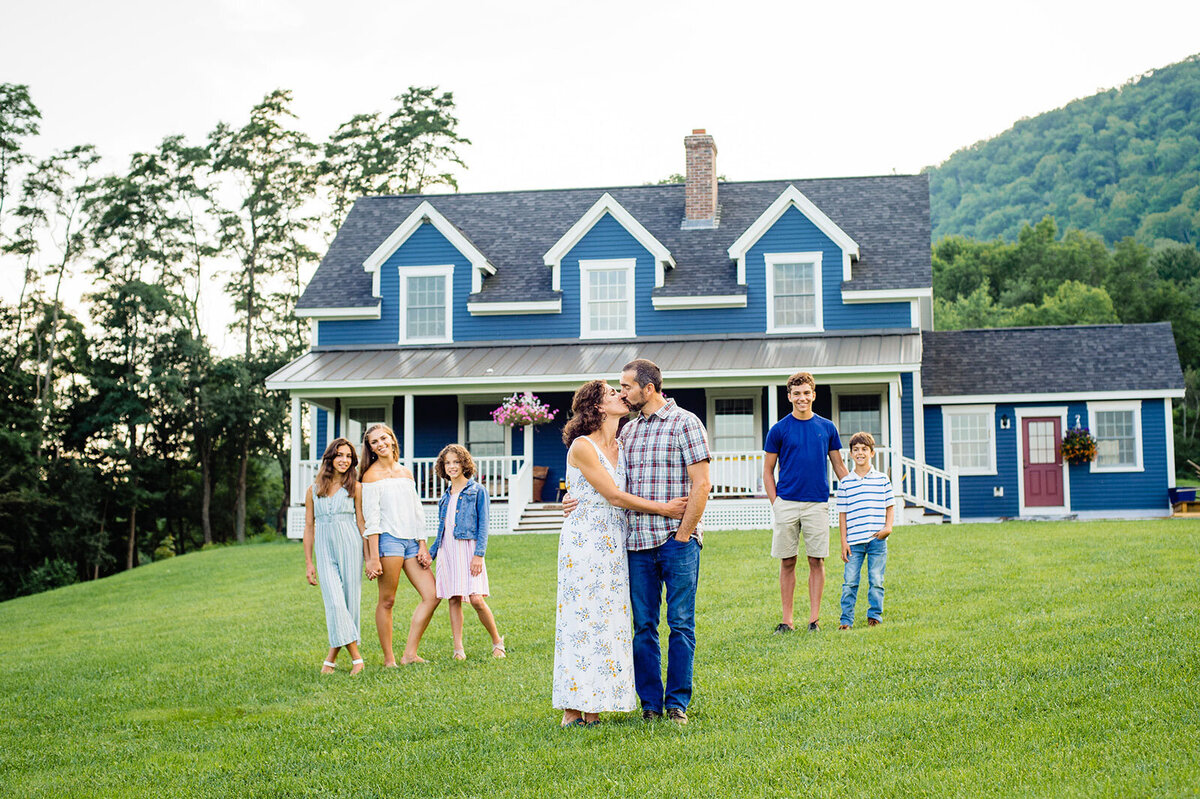 family in front of house in vermont