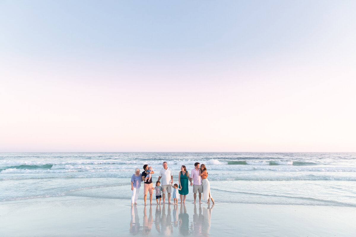 A family standing together along the ocean's edge