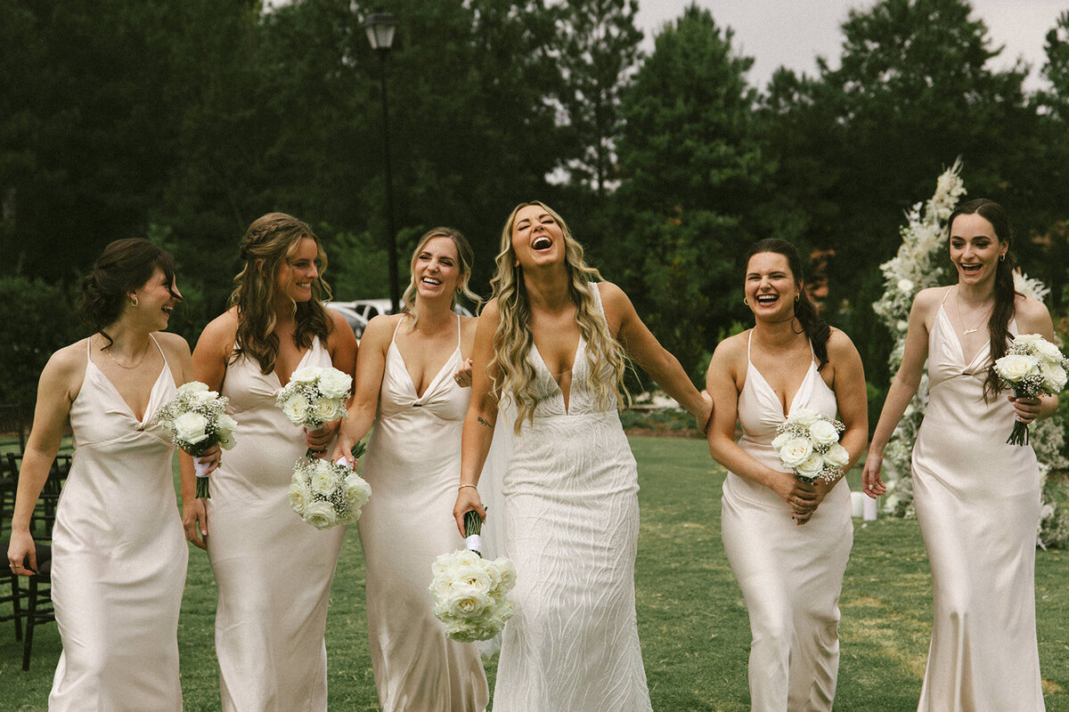 bridal party laughing wearing white