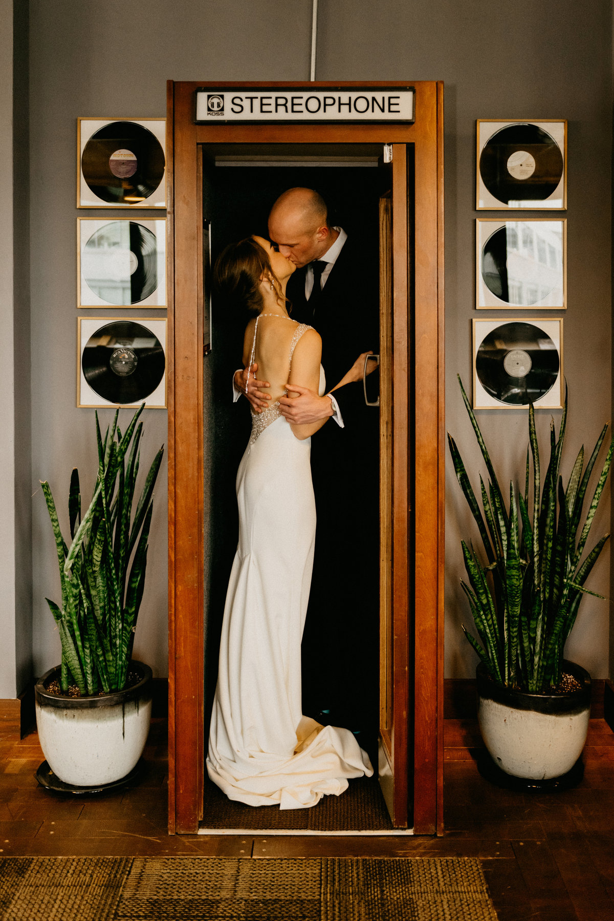 wedding couple kissing in booth