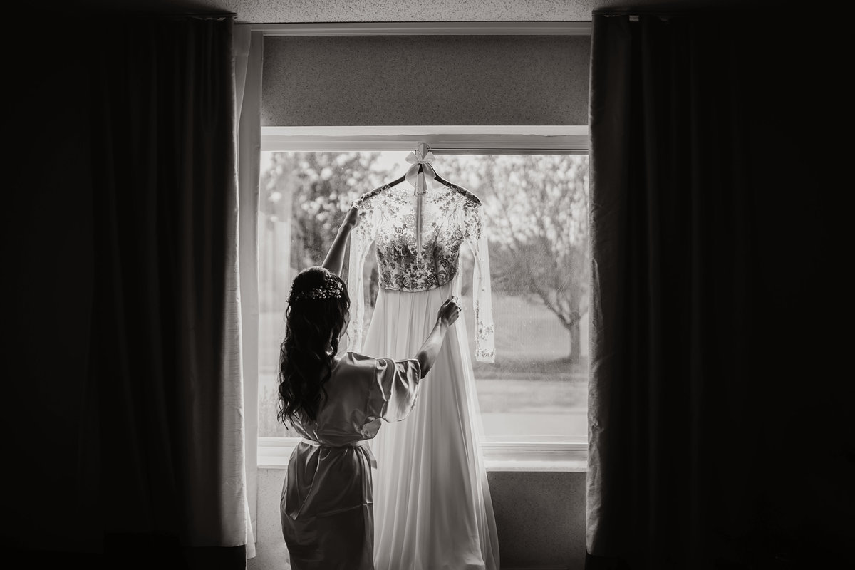 bride holding wedding dress