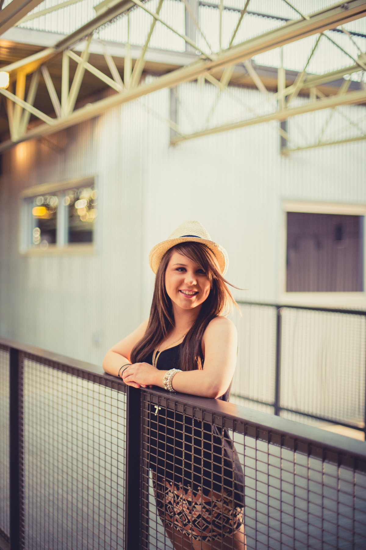 senior girl in high school posing wearing hat by San Antonio senior photographer