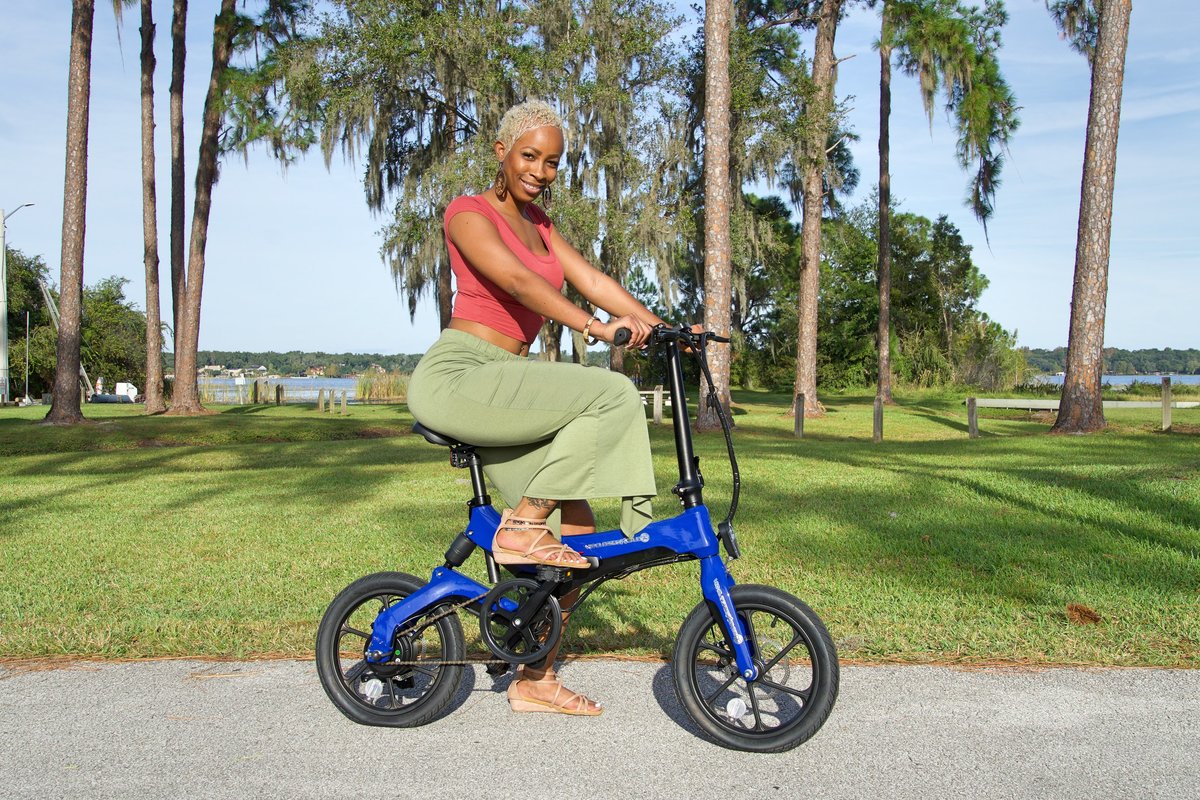 Lady riding Blue Go-Bike M4 in the park