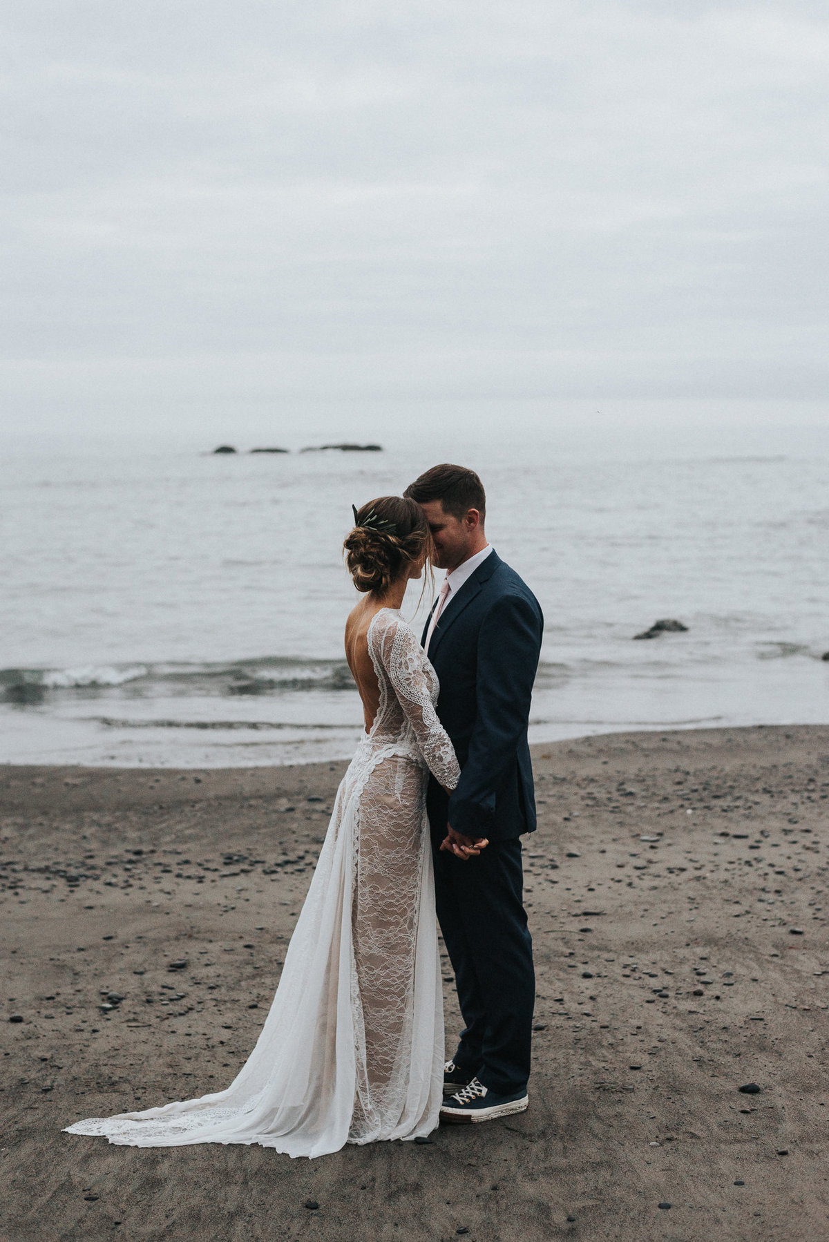 Bride and groom portrait of an elopement wedding in Forks Washington on the moody beaches of Rialto Beach.