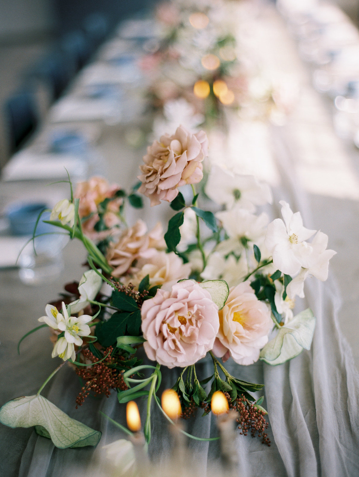 close up of garden roses on table during reception at wedding in DTLA