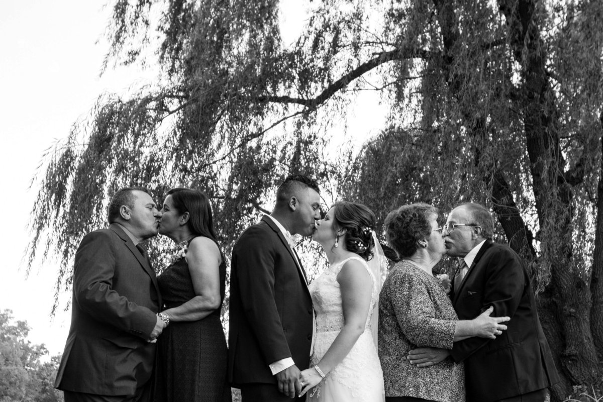 couple and both sets of parents kiss picture