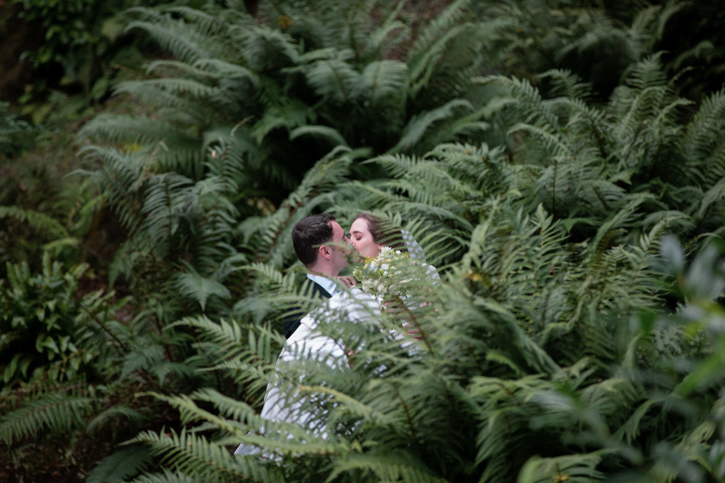 Couple kissing in the undergrowth at