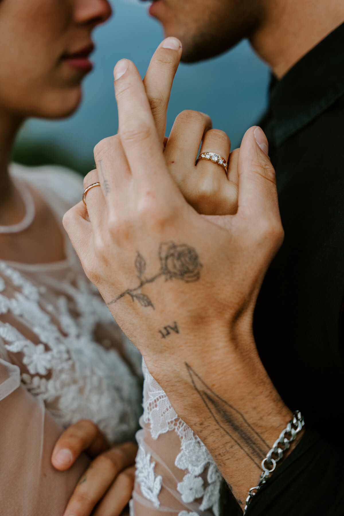 Couple eloping in the Italian Dolomites, closeup of their hands