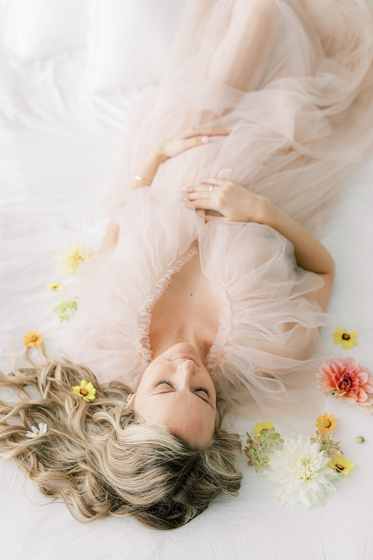 Expecting mother in a pink tulle gown with flowers