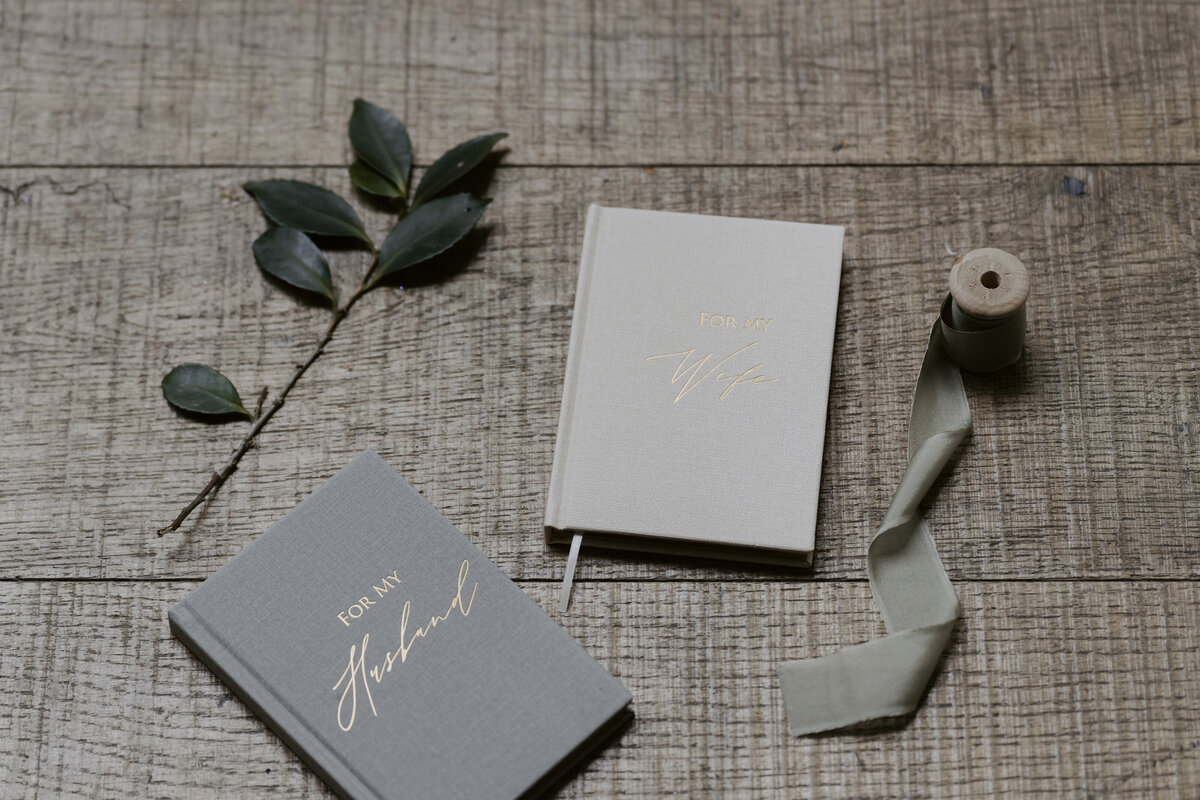 the couple's letter for each other with leaves and ribbon