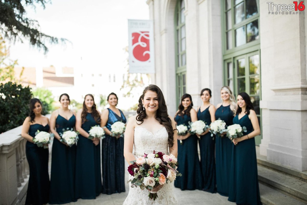Bride poses with her Bridesmaid in the background