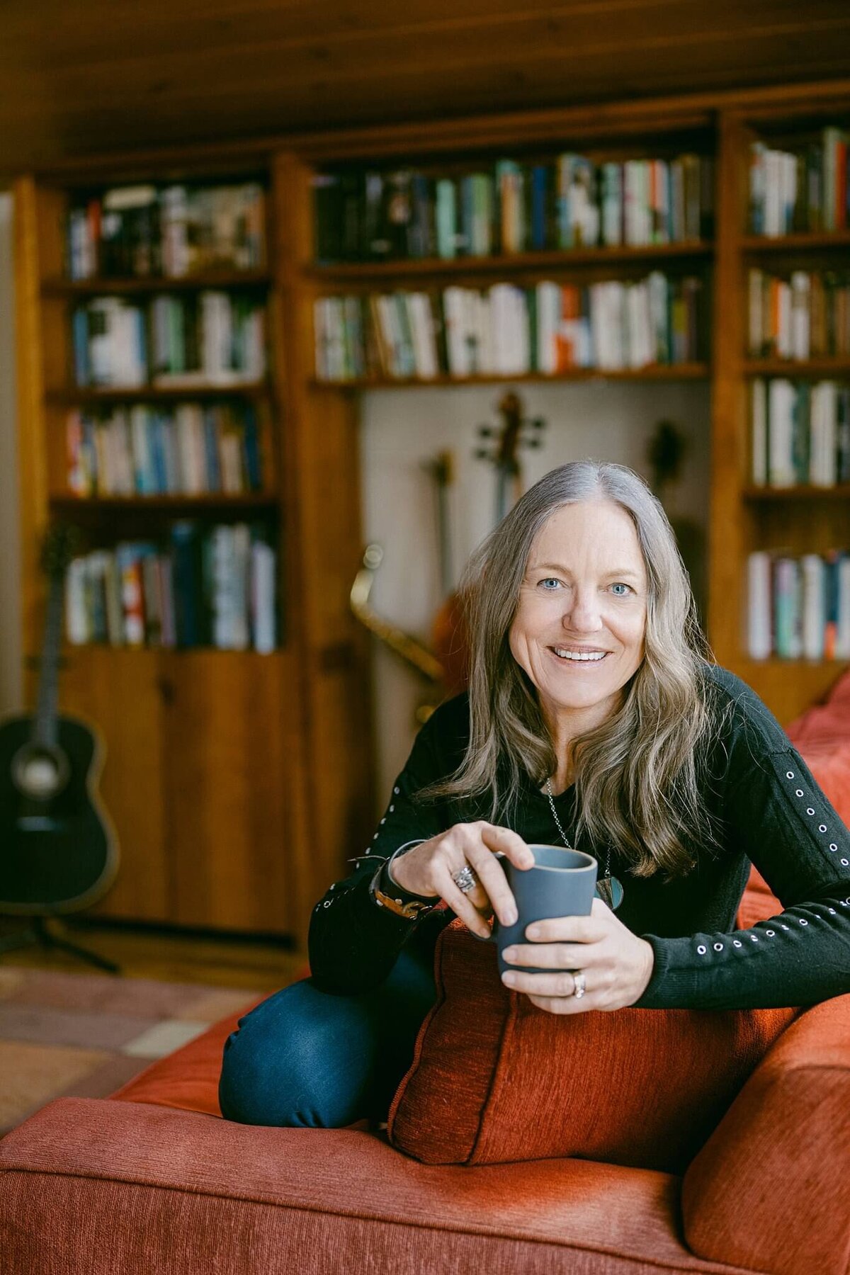 book author headshot in her living room with cup of coffee in Truckee