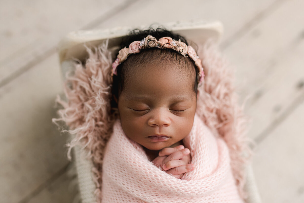 Newborn baby girl on pink in Photography studio in Birmingham al