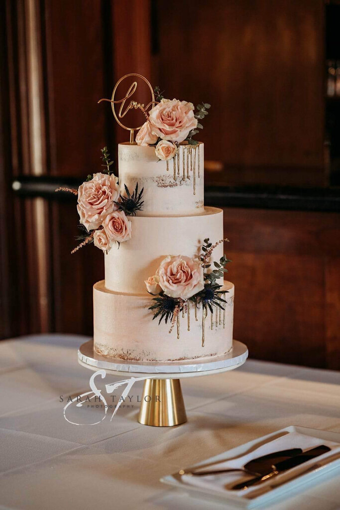 Elegant 3-tiered pink wedding cake with pink roses and gold dripping, created by Caroline Lem, chef and owner of Lemonberry Pastries in Calgary, Alberta