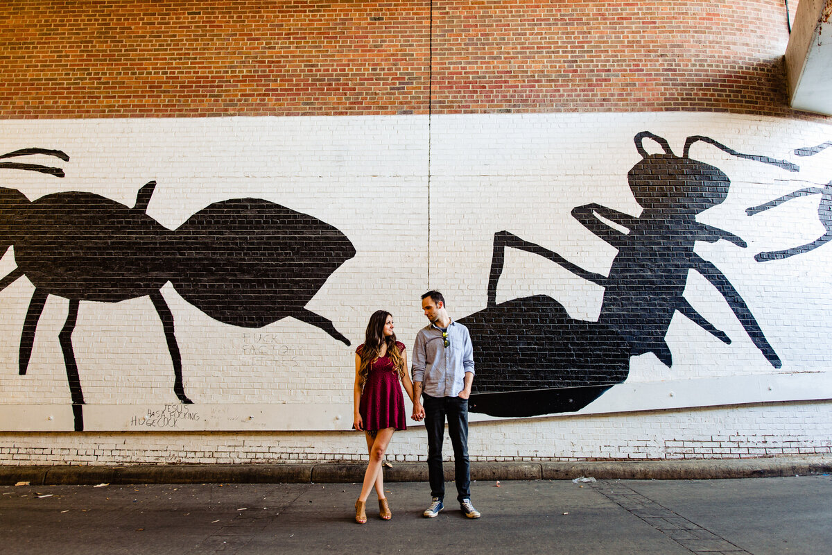 Downtown Ann Arbor Engagement photo in front of a mural of giant ants!  Photo By Adore Wedding Photography. Toledo Wedding Photographers