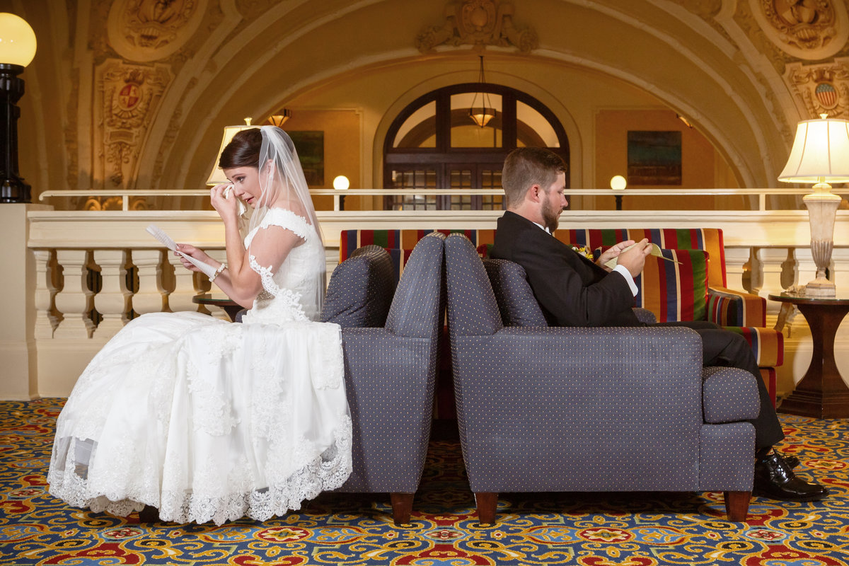 The bride and groom read notes to each other before their first look at The Battle House Hotel in Mobile, Alabama.