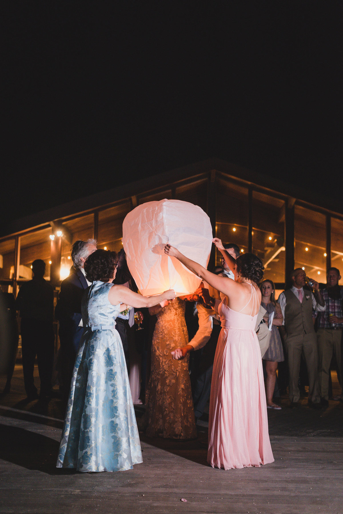 night shot of bridal party before sparklers from beach wedding at Pavilion at Sunken Meadow