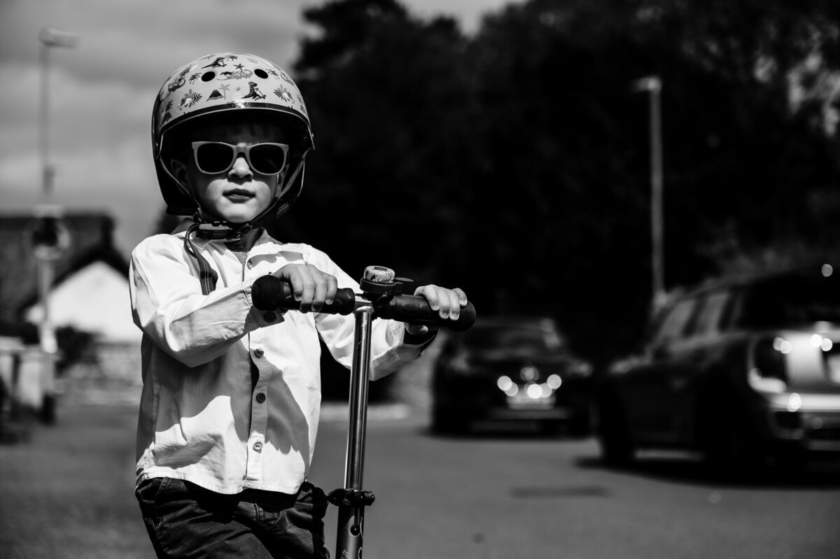 Little boy on his scooter black and white image
