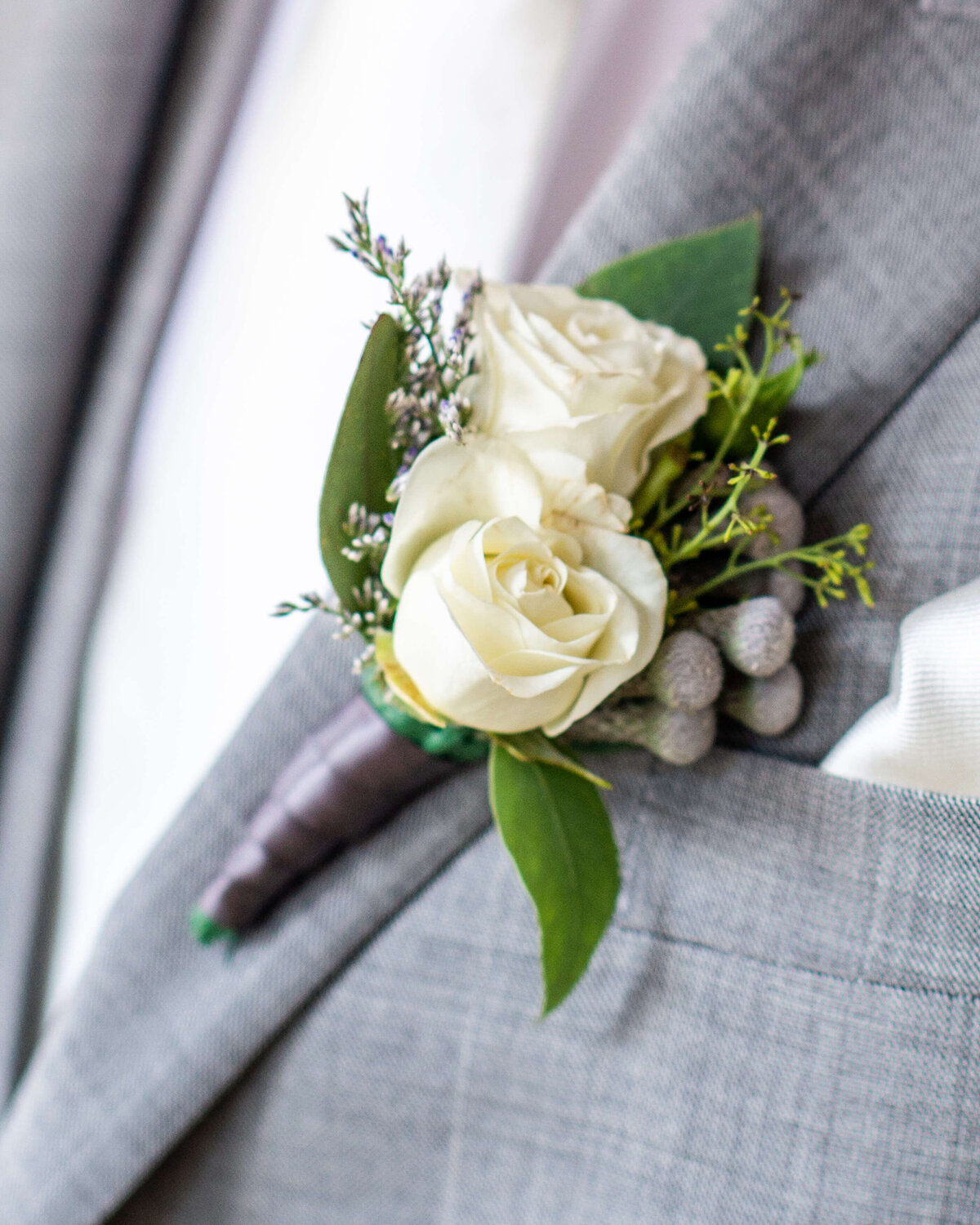 a closeup photo of a groom's boutonniere as he gets ready for his Ottawa wedding