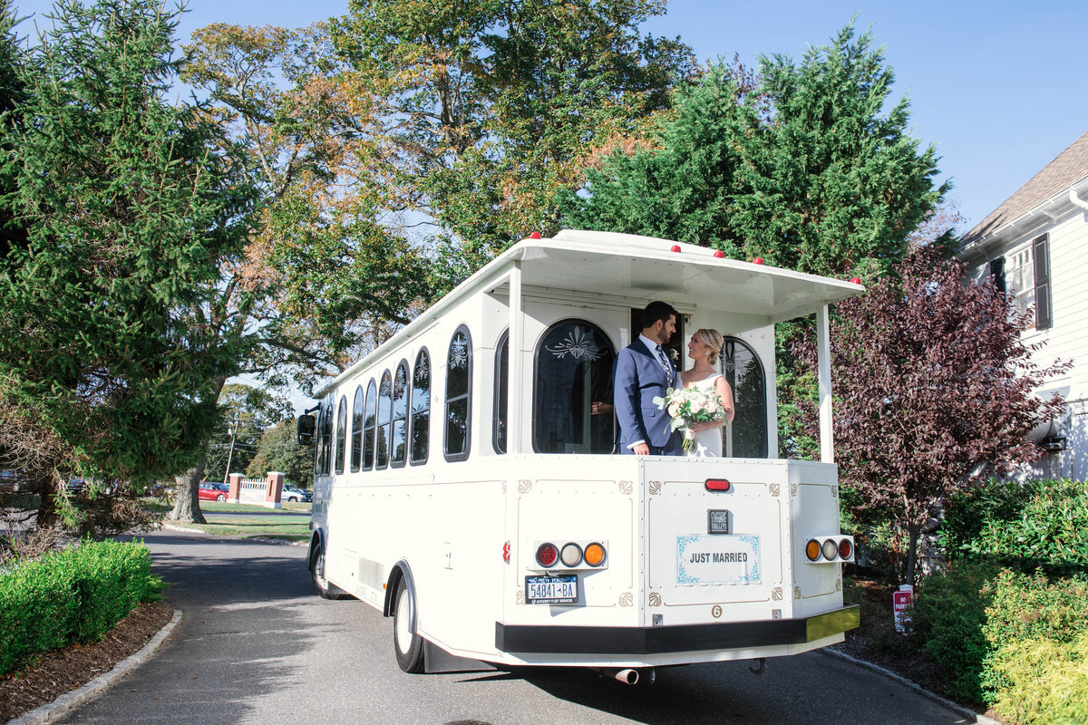 photo of bride and groom on trolly from wedding at Mansion at Timber Point