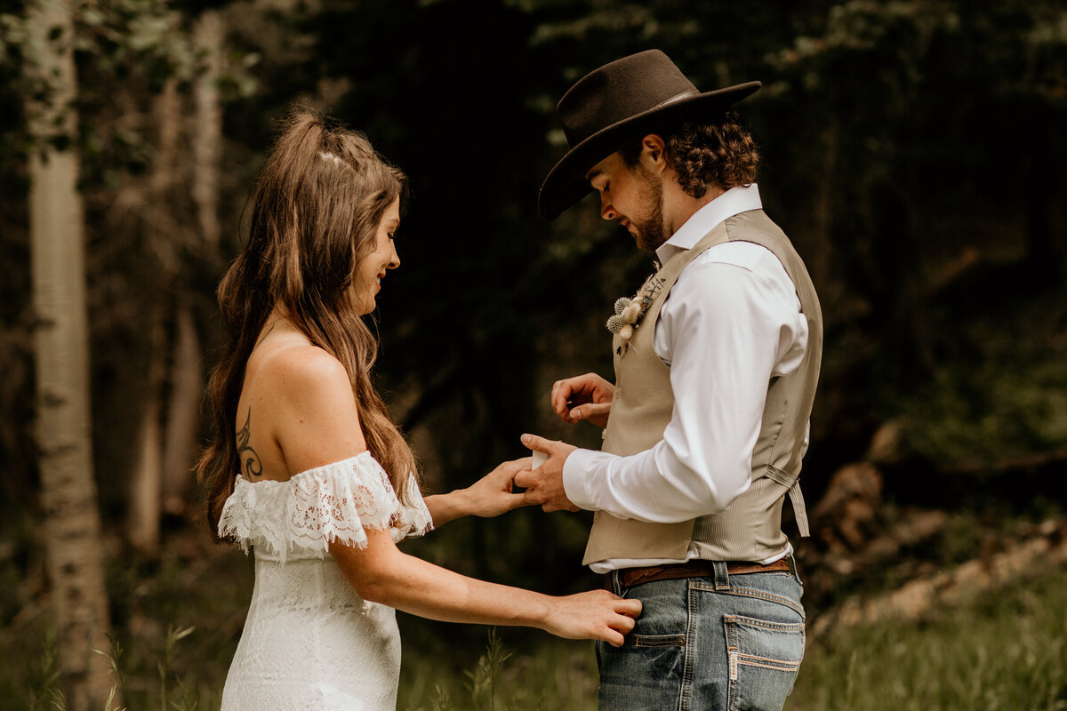 groom placing ring on brides finger in New Mexico