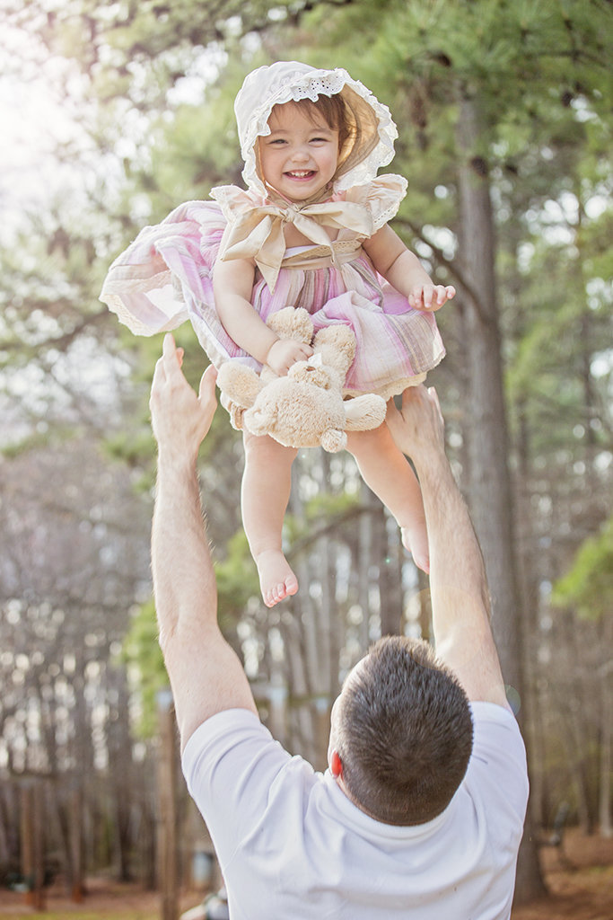 charlotte family photographer jamie lucido captures beautiful father daughter portrait, child laughing in the air above father