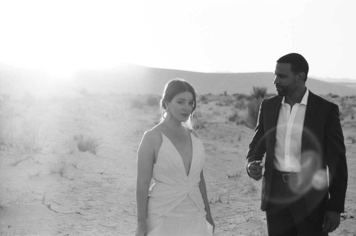 groom gazing at bride in white sands new mexico