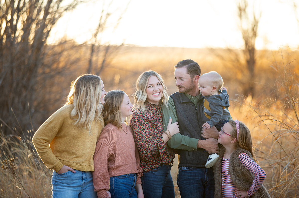 smiling family session in golden fields in swisher co